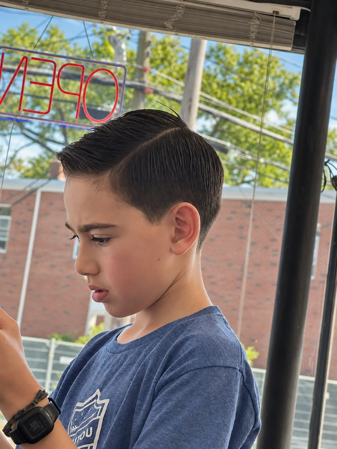 Close side view of a finished side-part haircut